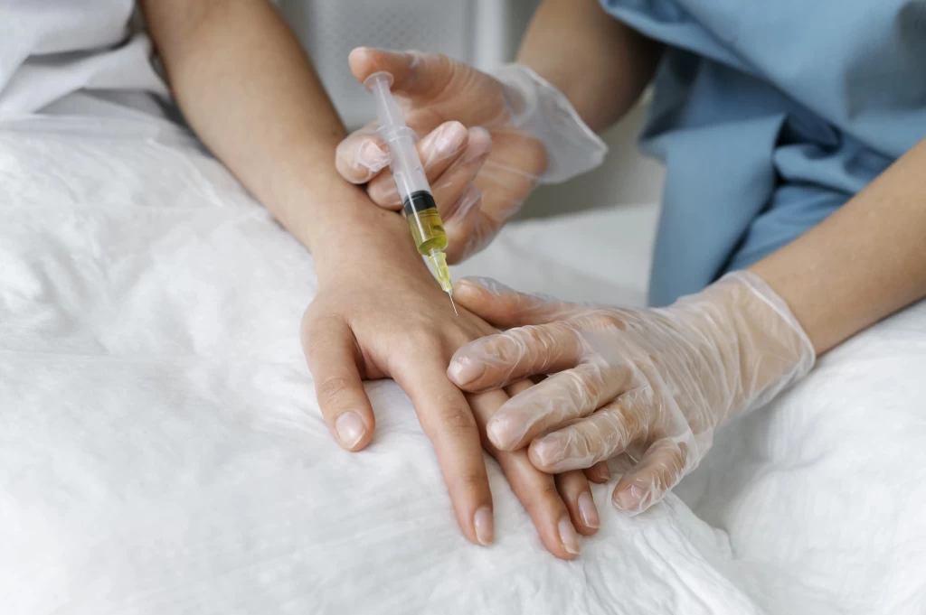 high-angle-healthcare-professional-injecting-arm-2-1024×681